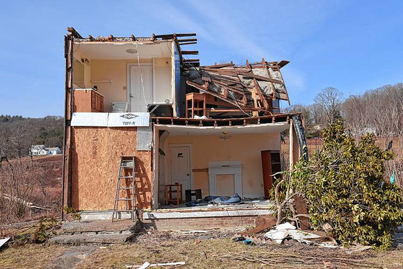 The roof and front part of the Thomas home were destroyed by the tornado in Conway