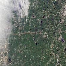 A satellite view of the tornado's path. The track can be seen as a brown streak across the center of the image; part of the track, including Springfield, is obscured by clouds.