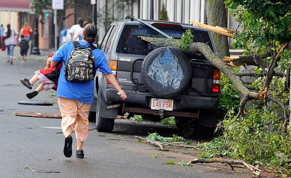 A woman runs with her child to safety after another report of a possible tornado in Springfield, Mass.