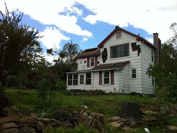 A damaged home in Monson