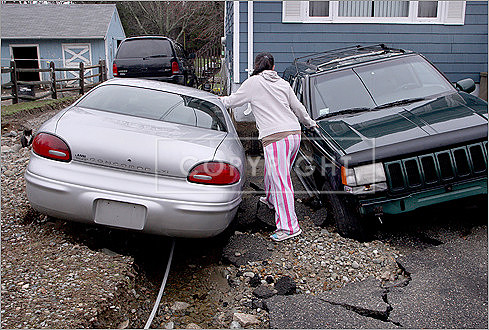 April Camara inspected her cars in her Freetown driveway.