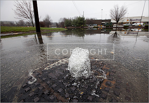 A manhole cover was overflowing off of Skillings Road near Winchester High School