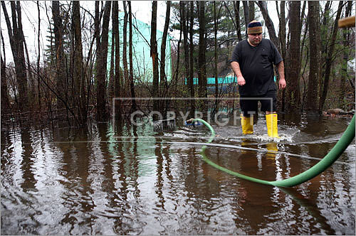 Mark Zipeto slogged through his Holbrook front yard.