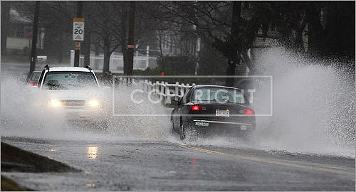Cars kicked up a surf on Route 150 in Amesbury.
