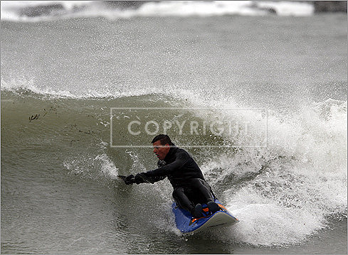 A sea kayaker gets caught up in a wave while taking advantage of heavy surf along Kennebunk Beach