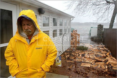 The rising water from Watuppa Pond in Fall River lapped at Arthur Pires's back deck