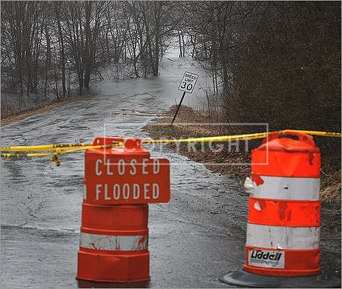A wet, and closed, Pelham Island Road in Wayland.