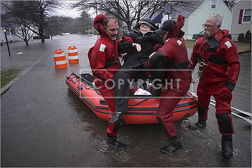 Virginia Russell was carried out of a raft after being evacuated from her home in Cranston, R.I.