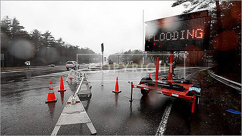 The Cambridge Turnpike at Crosby's Corner was closed after Crosby Pond flooded in Concord.