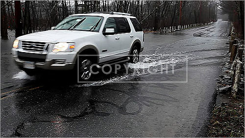 Another car made its way through washed out streets in Concord.