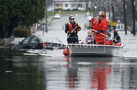 West Warwick, R.I., firefighters evacuate residents from flooded homes near the Pawtuxet River.
