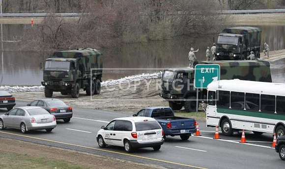 Members of the Rhode Island National Guard place sandbags along Interstate 295 at Exit 1 in Warwick, R.I