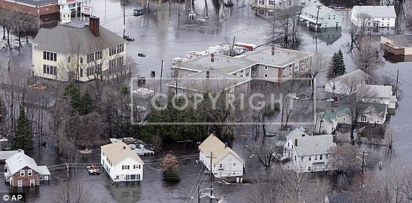 Water from a flooded river encircles homes in West Warwick, Rhode Island