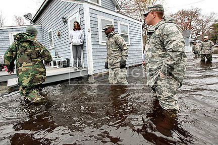 Kenna Chubbuck, who is standing outside her home in a flooded neighborhood of Freetown, Mass