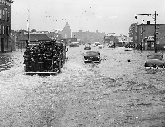 A fire tender being driven through a flooded street in New York on Sept. 16, 1960, in the wake of Hurricane Donna
